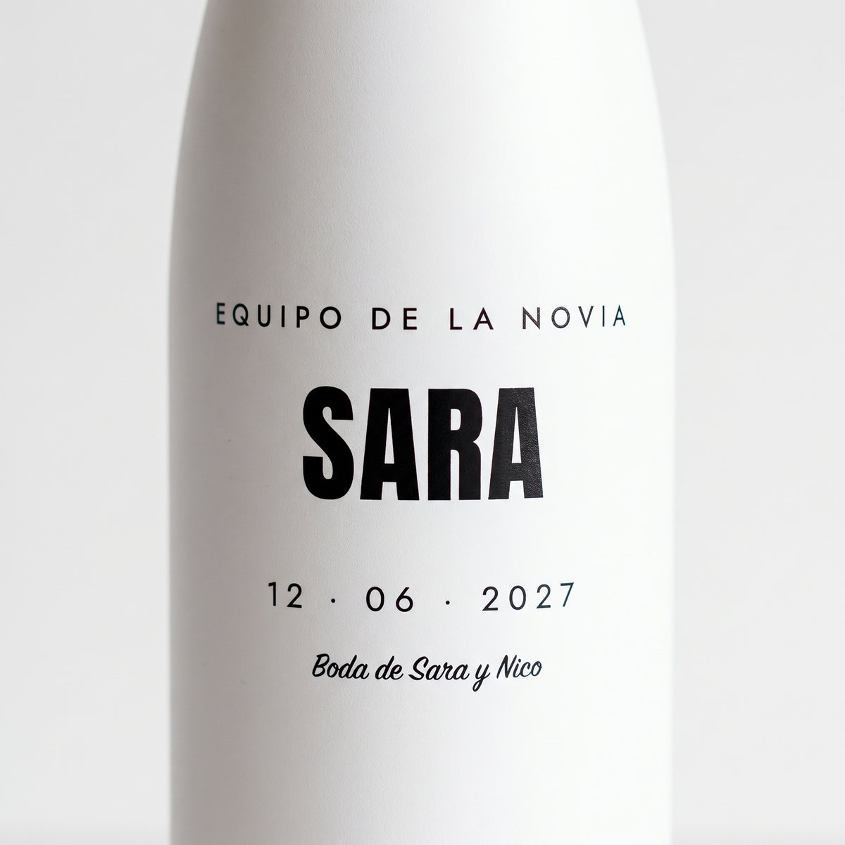 Detalle del nombre SARA con la fecha de la boda impreso en la botella