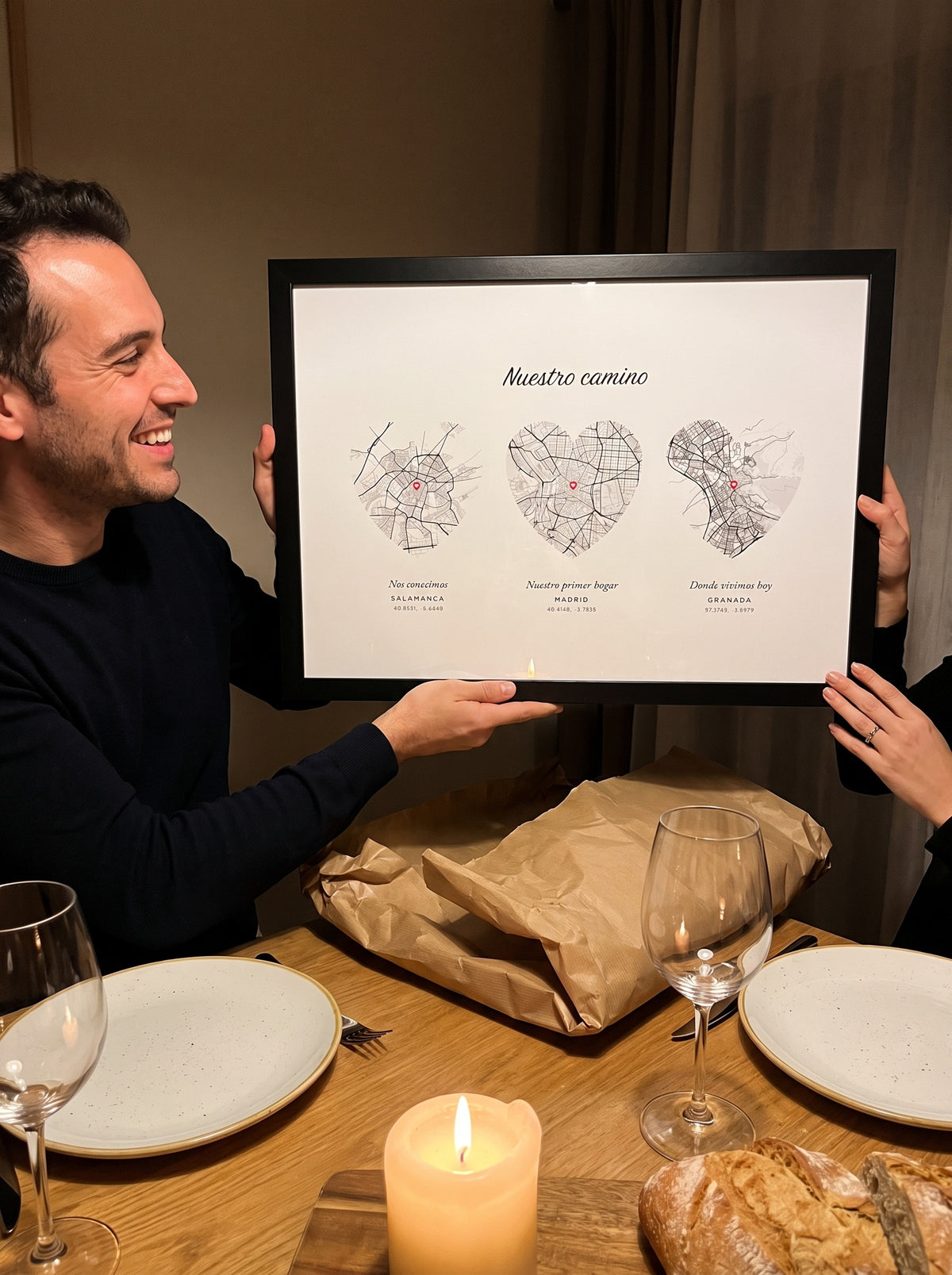 Un hombre desenvuelve en una cena de aniversario el cuadro con los mapas de Salamanca, Madrid y Granada