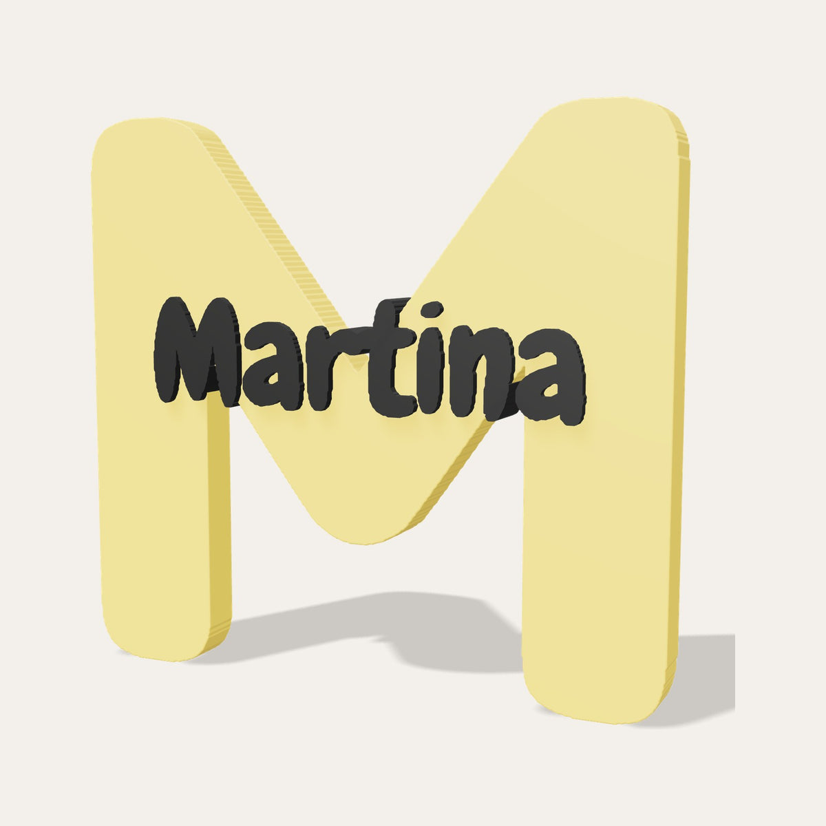 Letra 3D M amarilla con el nombre Martina en relieve negro
