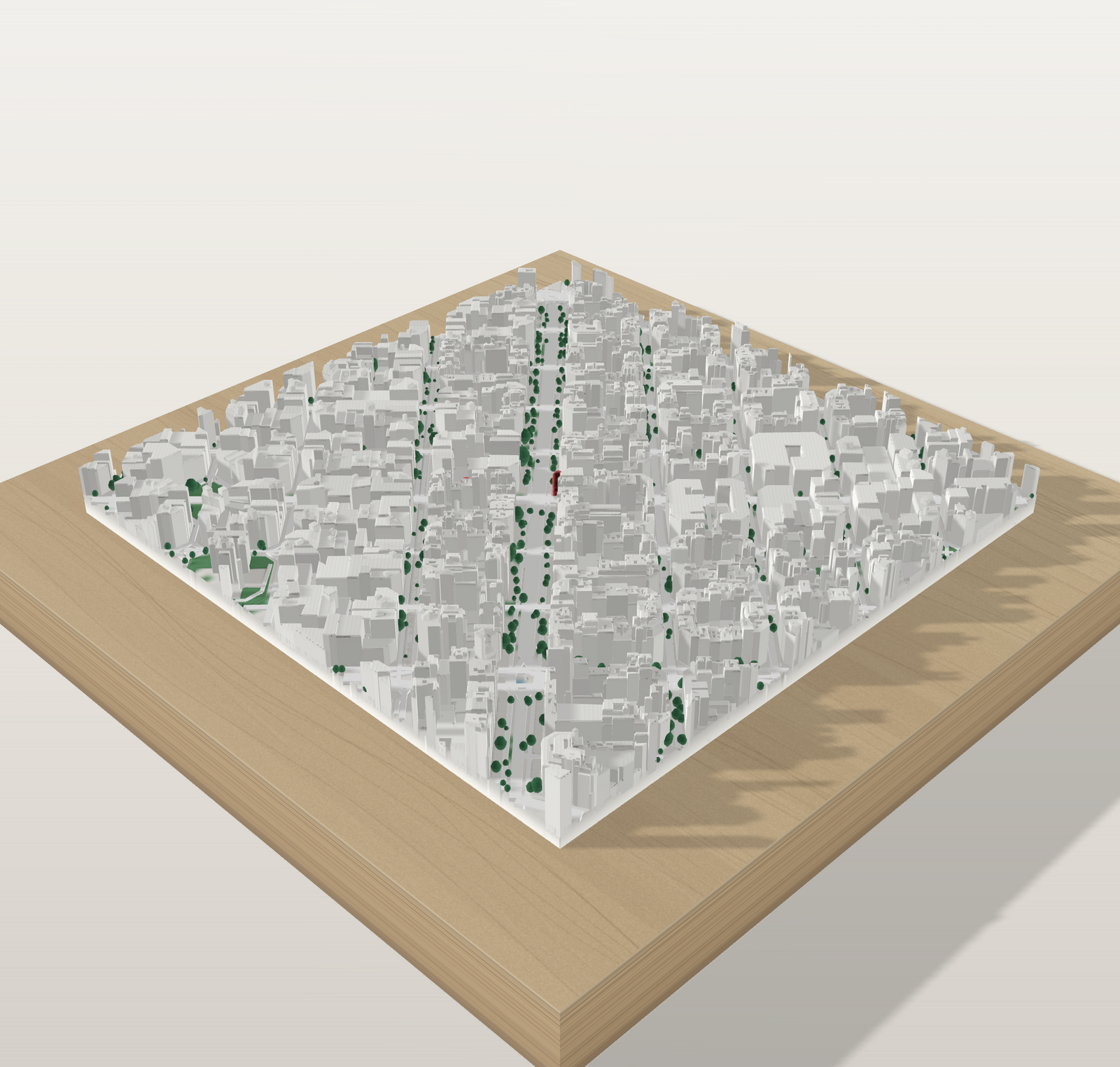 Mapa 3D personalizado del Eixample de Barcelona con el agua en azul y los parques en verde, sobre tabla de pino