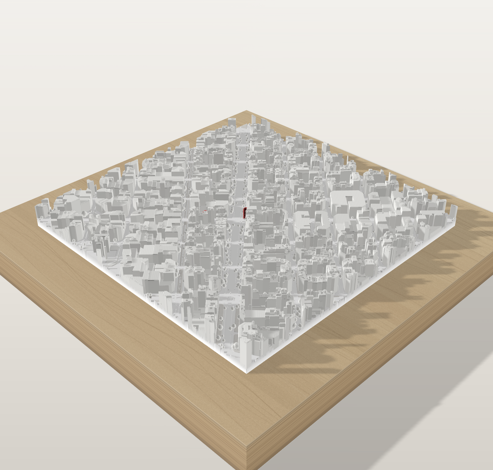 Maqueta 3D de una ciudad en blanco sobre tabla de pino maciza, con las calles y los edificios en relieve
