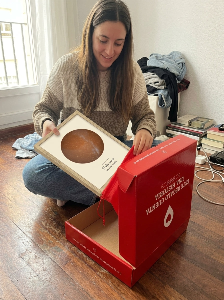 Sacando el cuadro mapa estelar personalizado de pedida de mano de la bolsa de regalo, con la caja abierta al lado